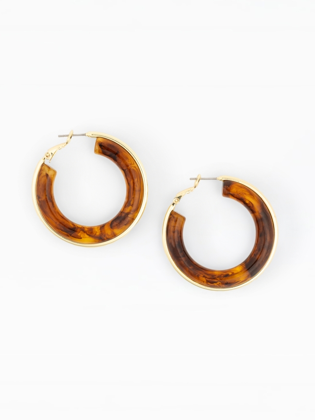 Pair of Esme hoop earrings featuring a brown tortoiseshell resin design with gold-plated metal trim.