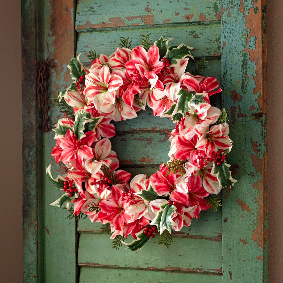 Round peppermint green Amaryllis wreath with white flowers on a natural branch base.