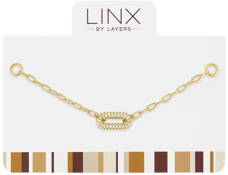 Gold paperclip chain add-on featuring a central oval link encrusted with clear cubic zirconia.