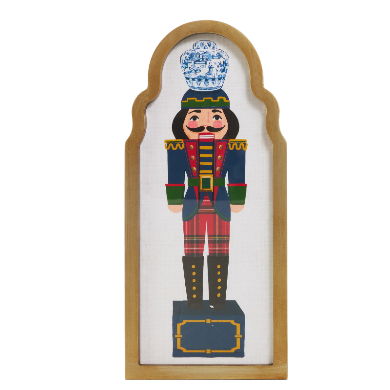 15.75-inch framed wall art featuring a nutcracker with a blue and white ginger jar on its head.