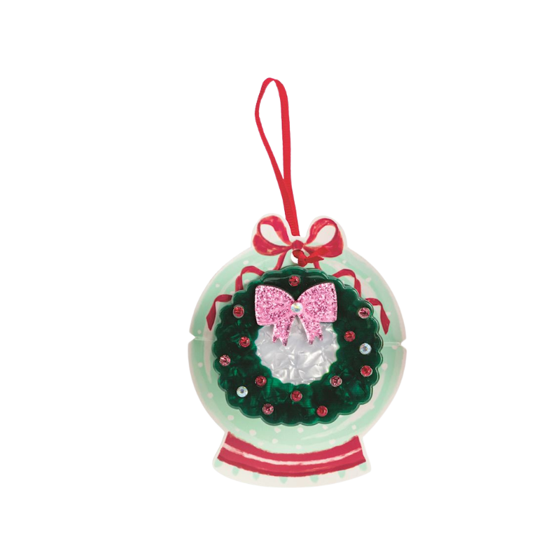 Holiday claw clip featuring a green wreath with a pink glitter bow on an ornament display card.