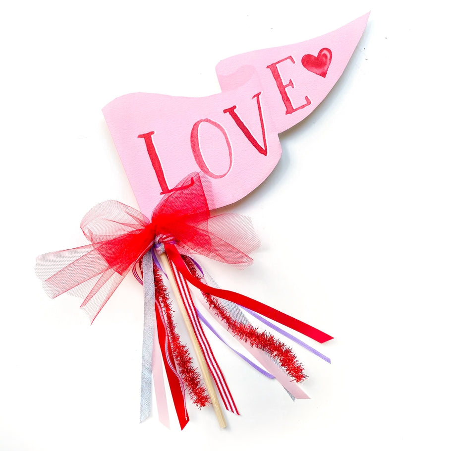 Assembled party pennant flag on a wooden dowel featuring whimsical watercolor illustrations.