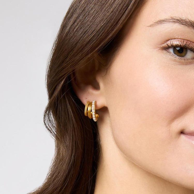 Triple hoop earring with gold plating, stone studs on the inner ring, fluted middle ridge, and braided outer edge.