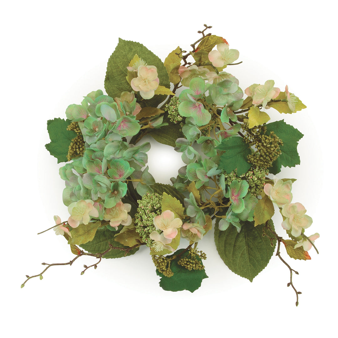 Circular fabric ring with lifelike hydrangea blooms and greenery in white and pink tones.