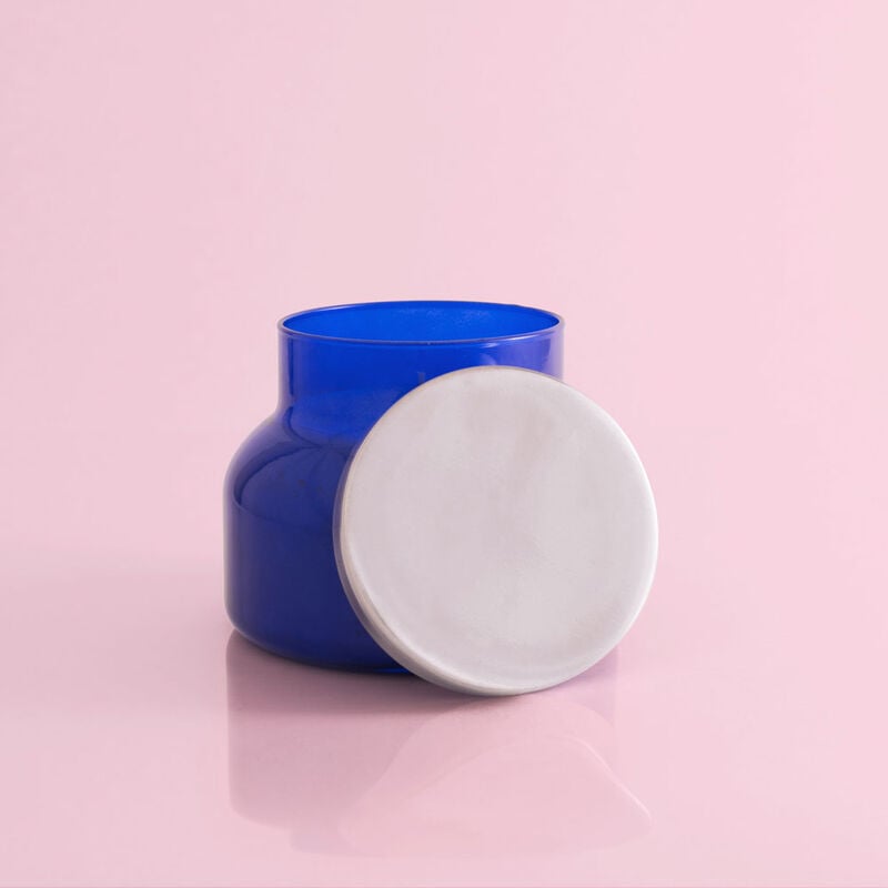 Volcano Blue Signature Jar candle in a cylindrical glass jar with a blue flame visible.