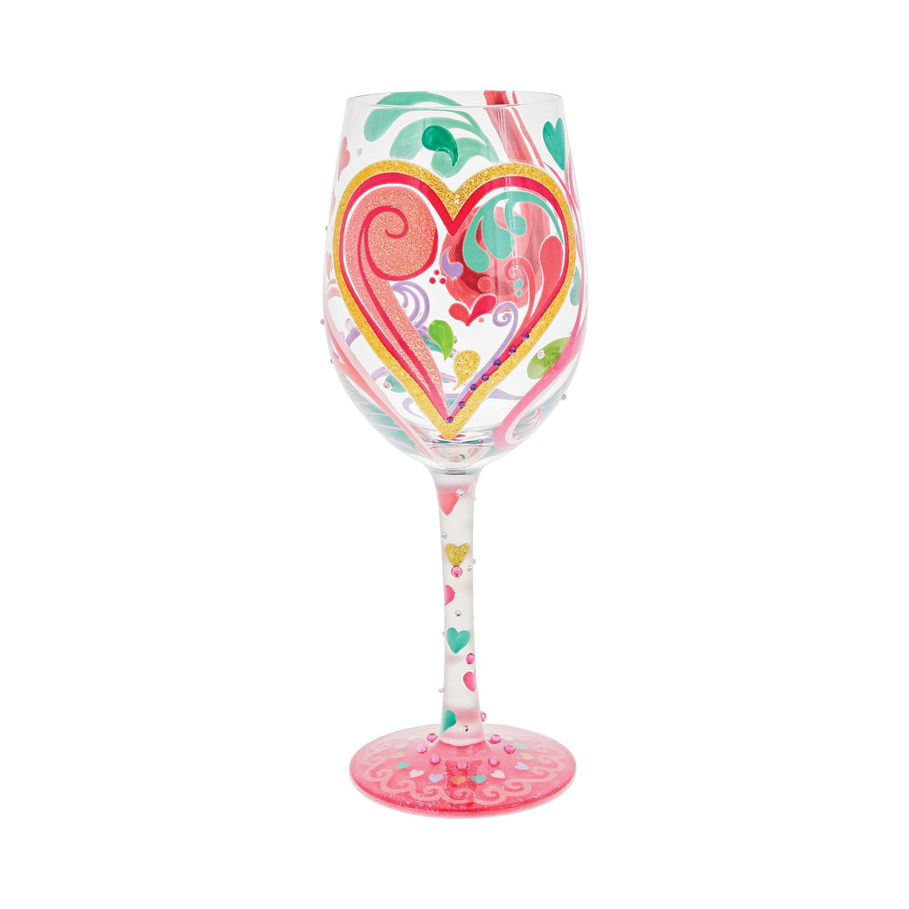 Blown glass wine glass with hand-painted colorful cocktail recipe base and glitter accents.