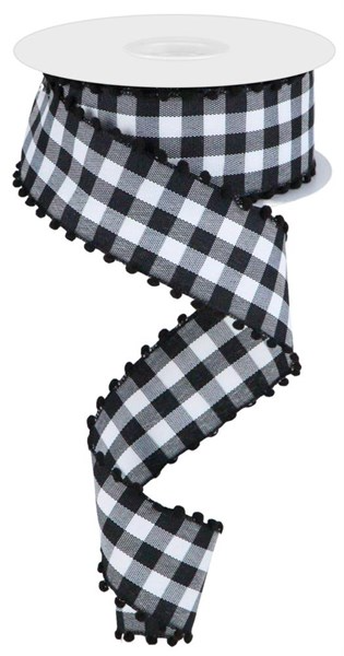 A roll of black checkered ribbon with white poms attached to the end.
