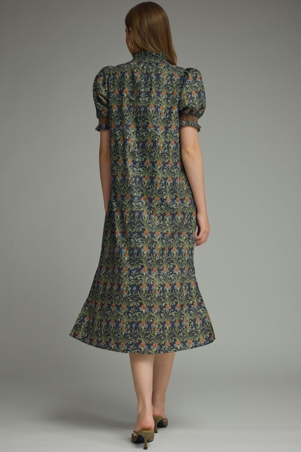 Back view of a woman wearing the Mary floral print midi dress with short puff sleeves.