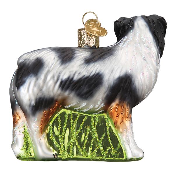 Glass Australian Shepherd Christmas ornament featuring a blue merle coat standing on green grass.