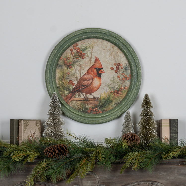 Round glass wall clock with a wooden frame featuring a holiday scene of red cardinals on branches.