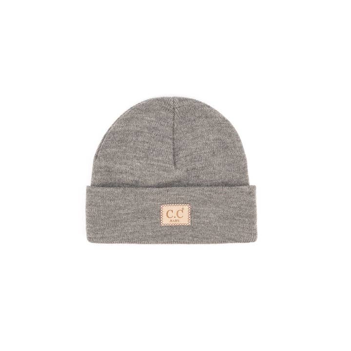 Baby ribbed beanie in solid cream acrylic knit with a folded brim silhouette.