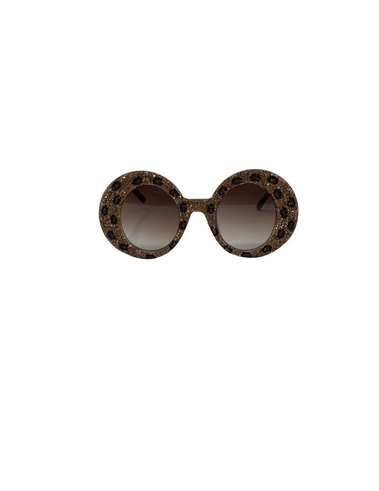 Round rhinestone sunglasses with a gold glitter frame and leopard print crystal patterns.