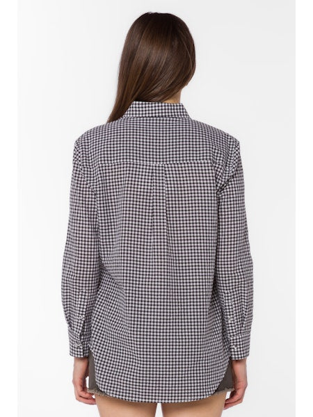 Oversized long-sleeve gingham print cotton shirt with button front closure in white and black.
