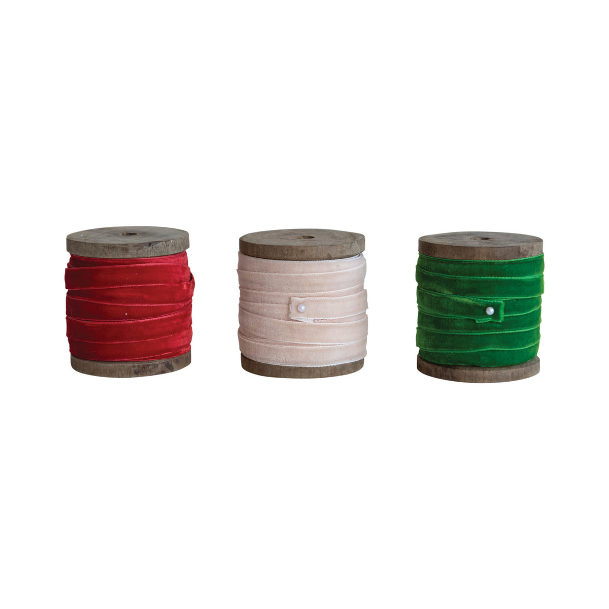 Three 10-yard velvet ribbons in red, cream, and green on rustic wood spools.