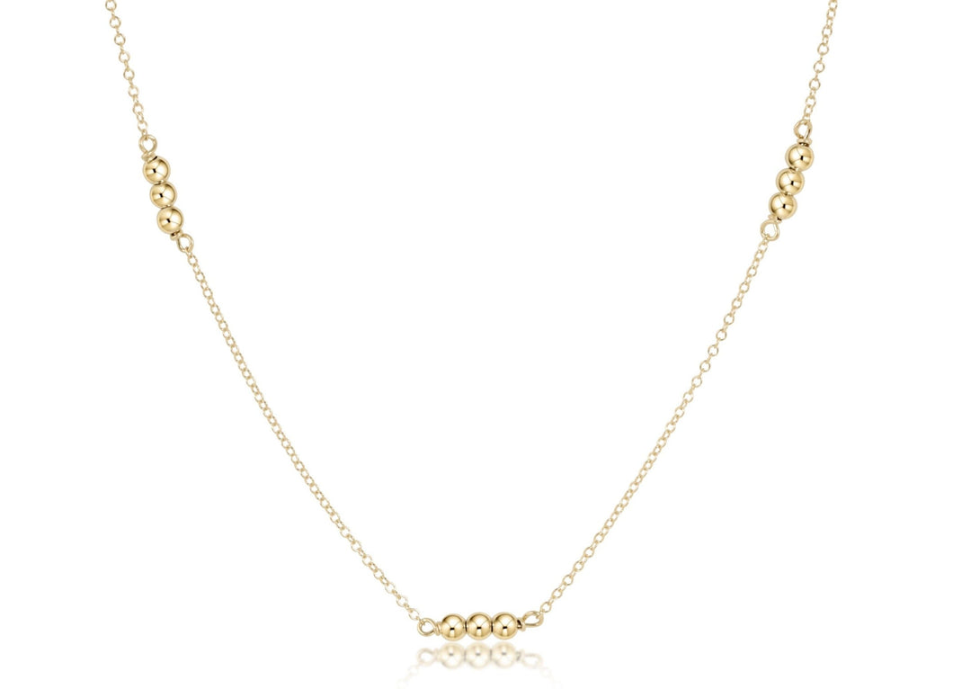 Gold-filled choker necklace featuring a delicate chain with small round beads.