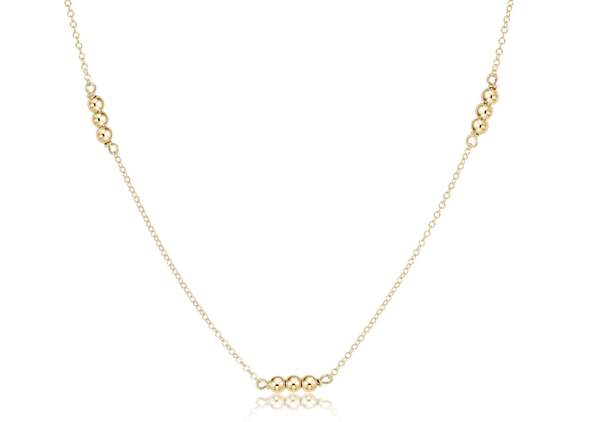 Gold-filled choker necklace featuring a delicate chain with small round beads.