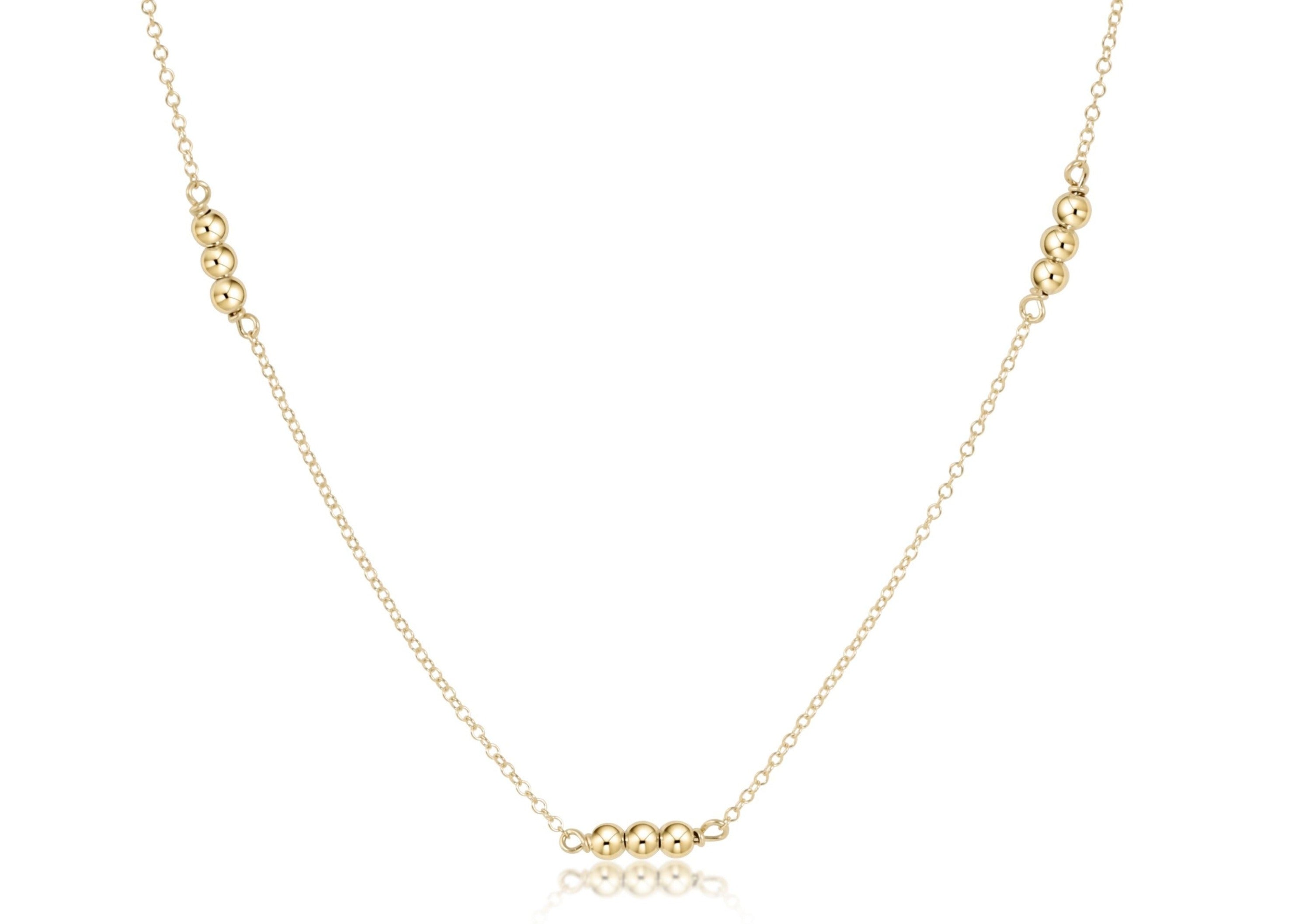 Gold-filled choker necklace featuring a delicate chain with small round beads.