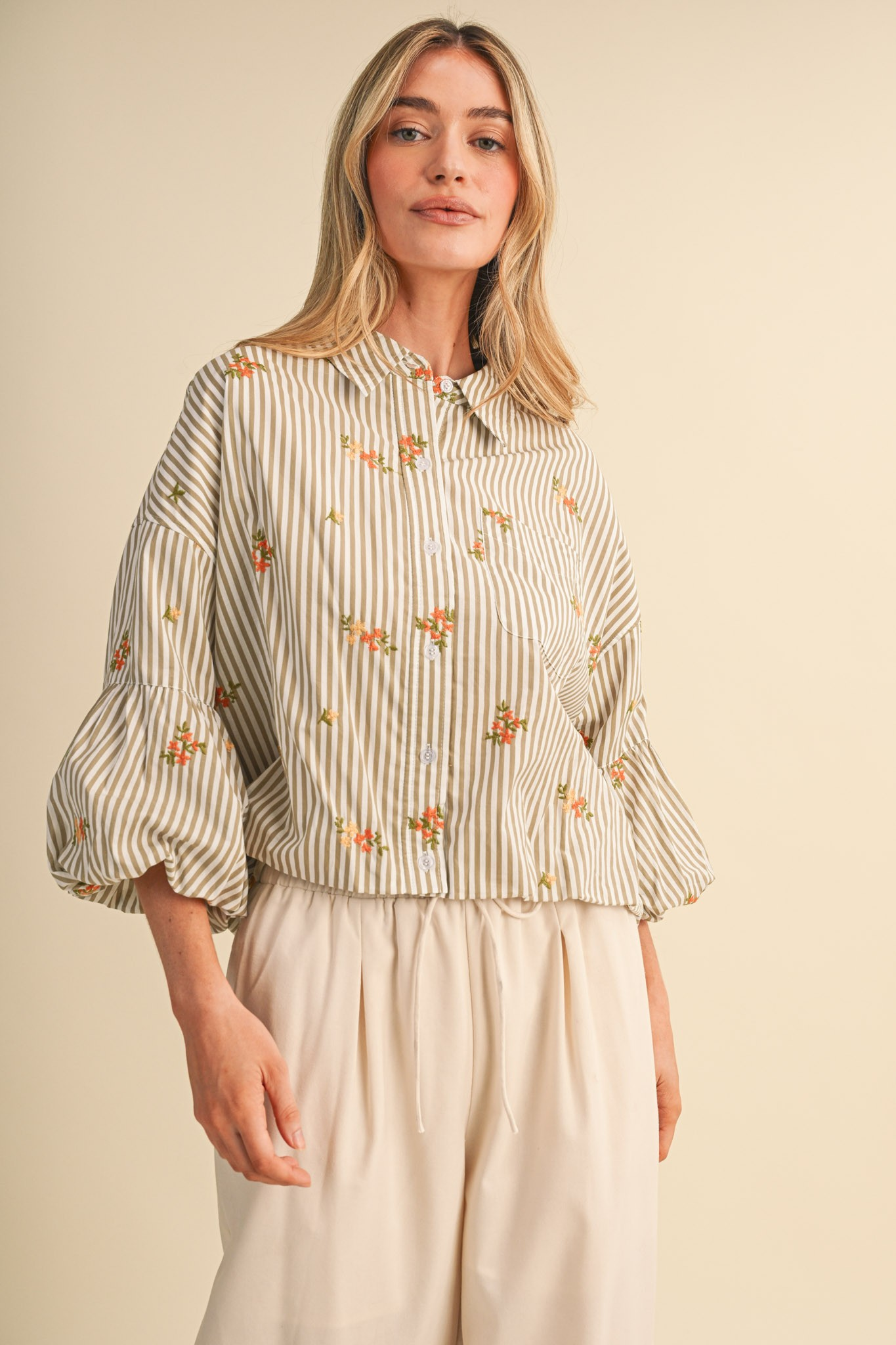 Aya striped floral embroidery button down top with 3/4 bubble sleeves and a collared neckline.
