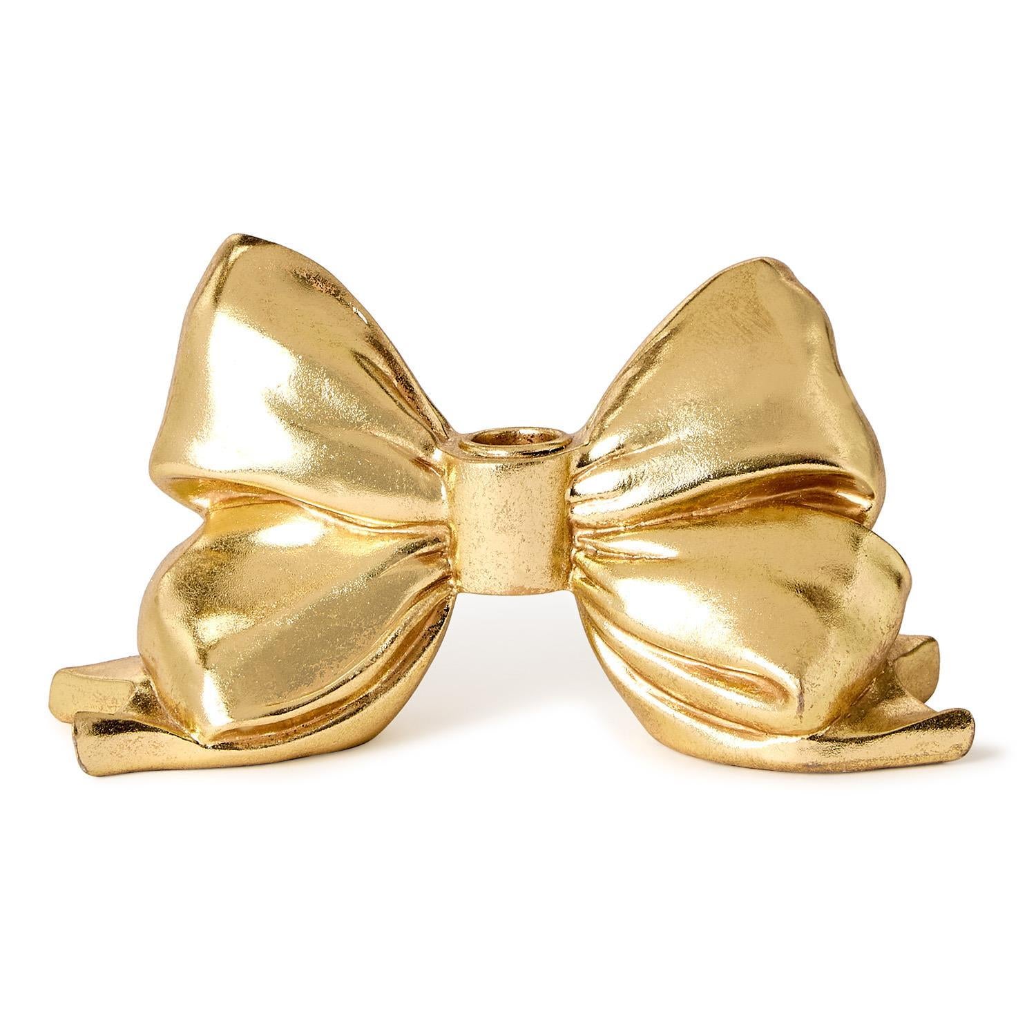Large gold metallic resin taper candleholder with a bow-shaped silhouette.