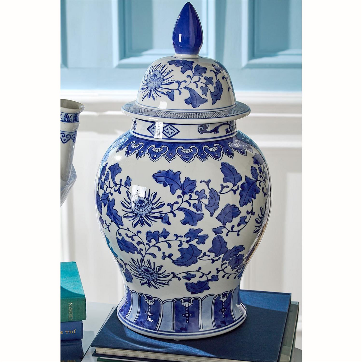 Canton ceramic ginger jar with a blue and white floral pattern and a pointed lid.