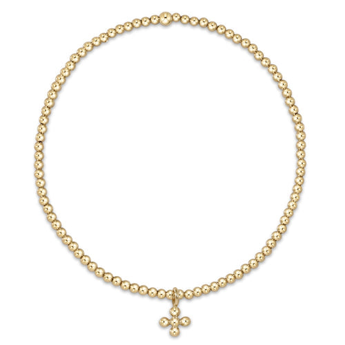 Classic Gold beaded bracelet featuring a small signature cross charm on elastic cord.
