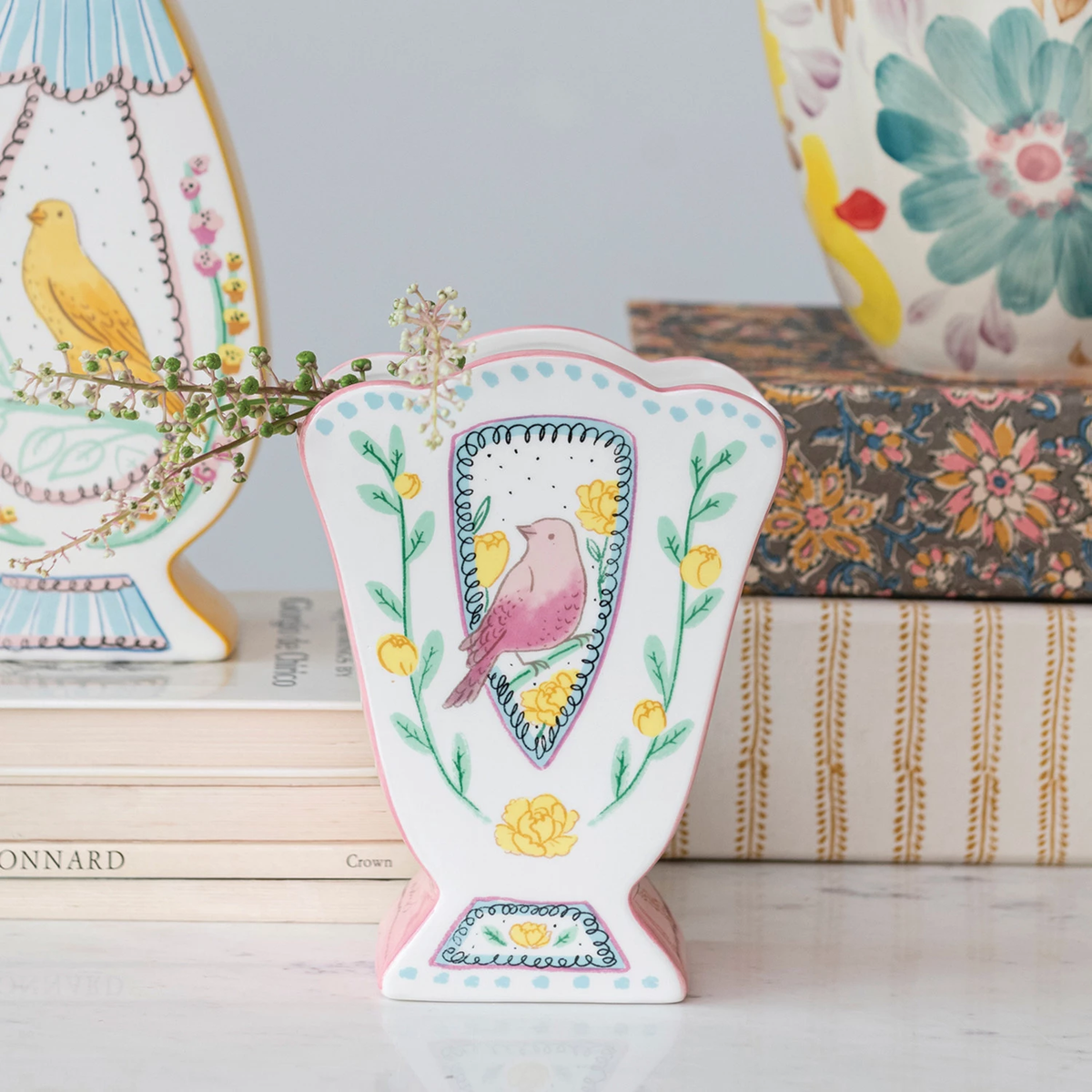 Ceramic fan-shaped dolomite vase with scalloped edge and bird motif pattern.