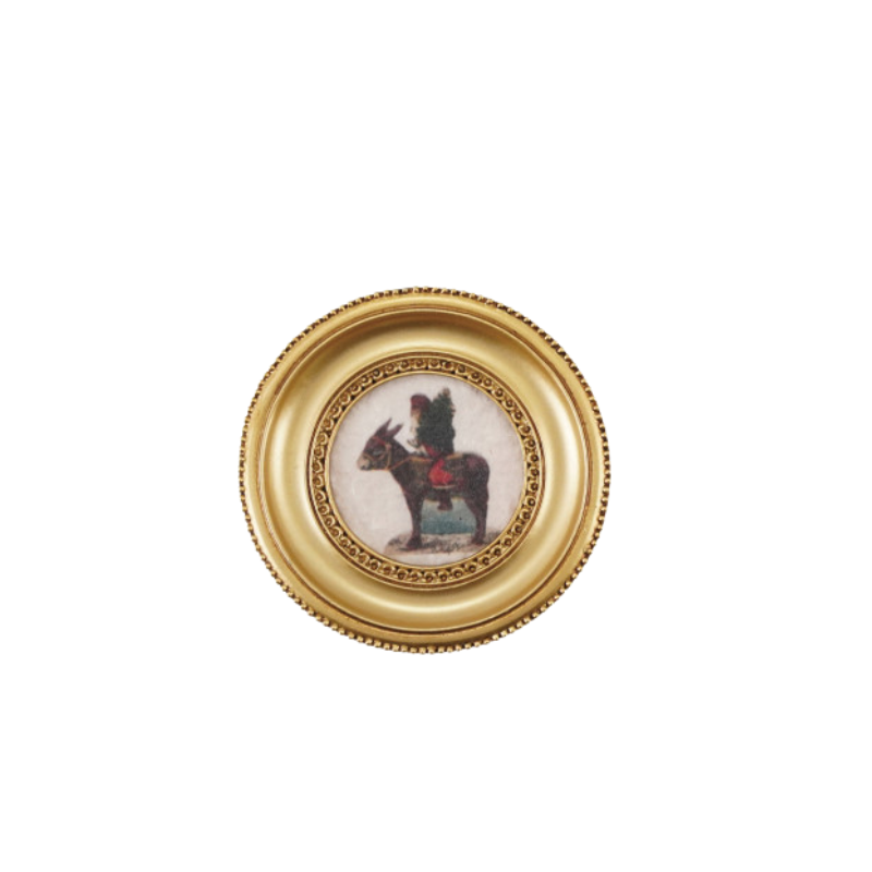 Round gold-framed resin magnet featuring a vintage illustration of a figure riding a donkey.