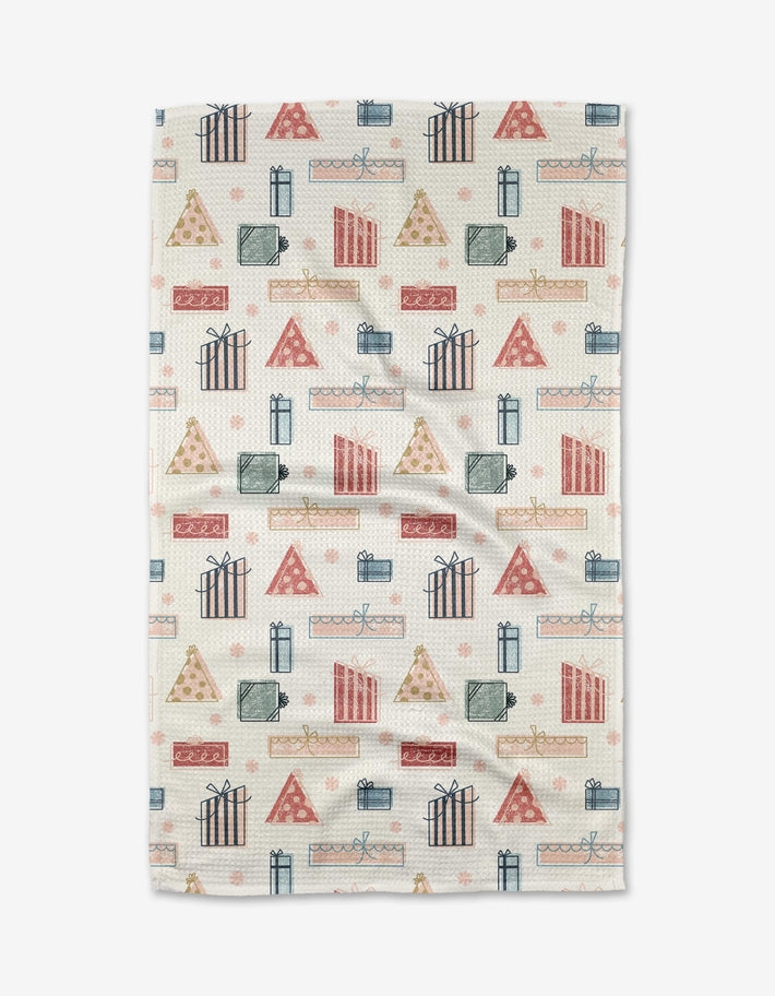 Holiday tea towel with waffle weave construction in red featuring festive snowflake pattern.