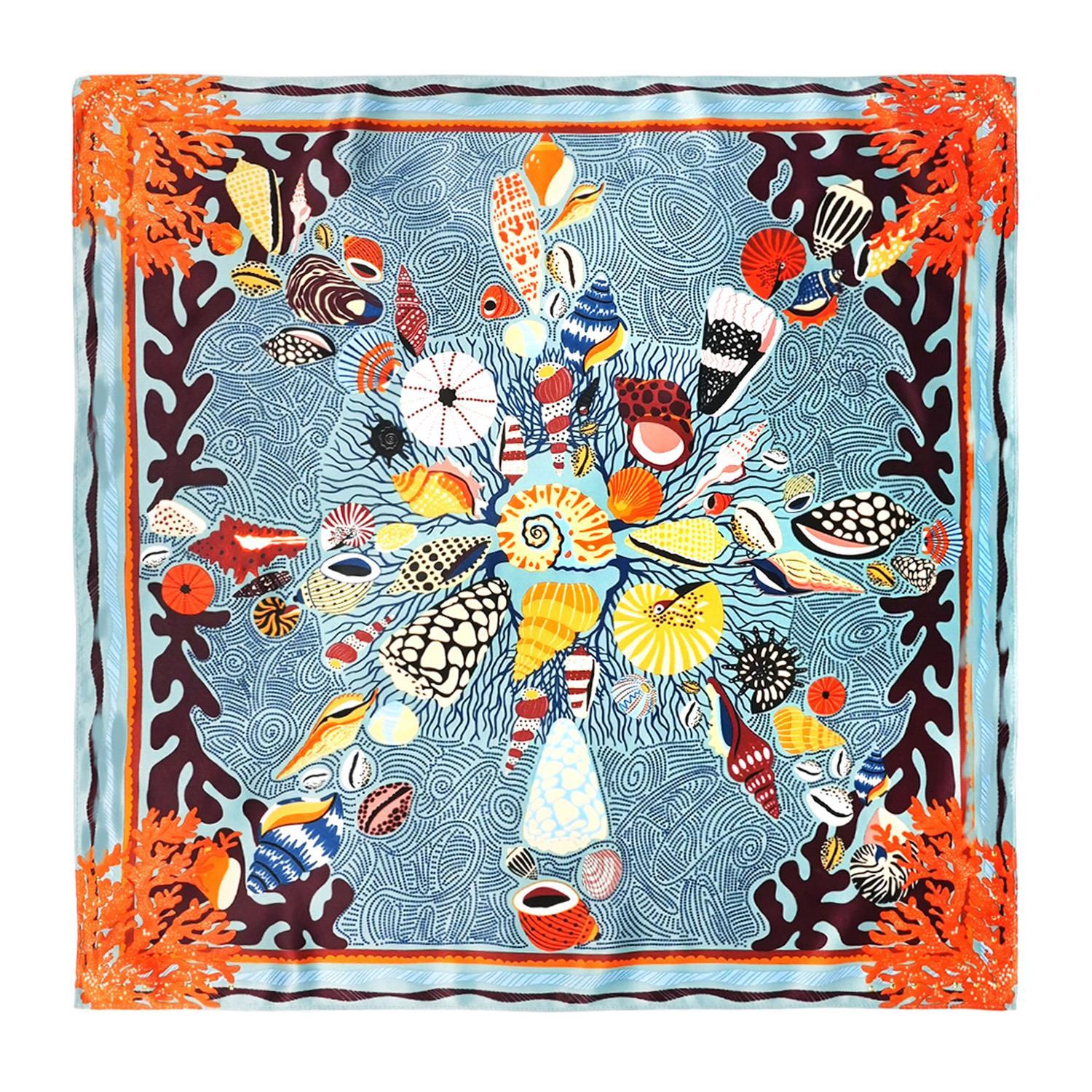 Mini square scarf with a colorful seashell and coral reef design on a blue patterned background.