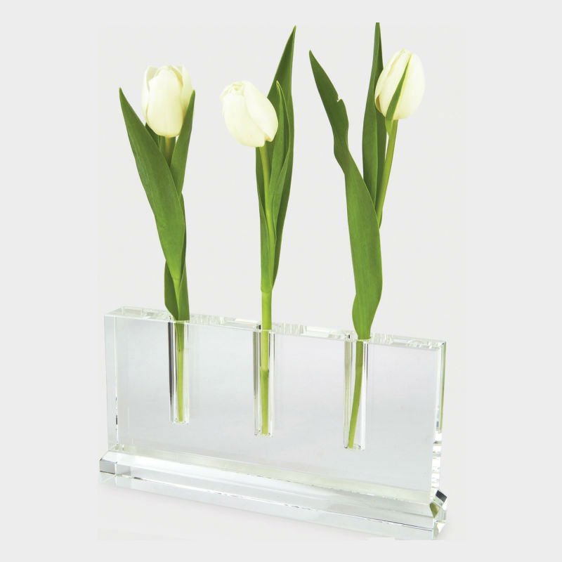Clear crystal glass bud vase with three holes holding a single stem.