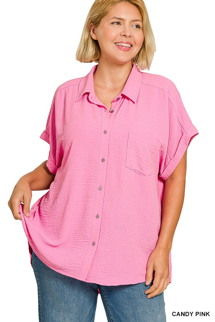 Woman wearing a candy pink plus size woven airflow button-down shirt with short sleeves and pocket.