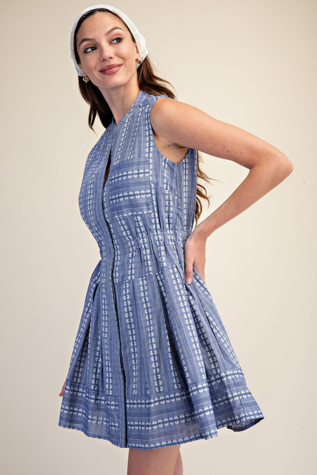 Sleeveless blue and white embroidered fit and flare mini dress with a V-neckline.