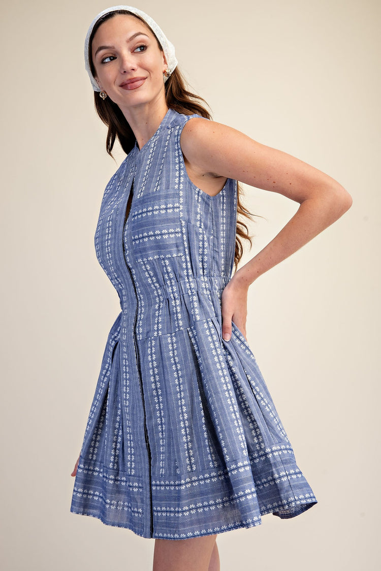 Sleeveless blue and white embroidered fit and flare mini dress with a V-neckline.