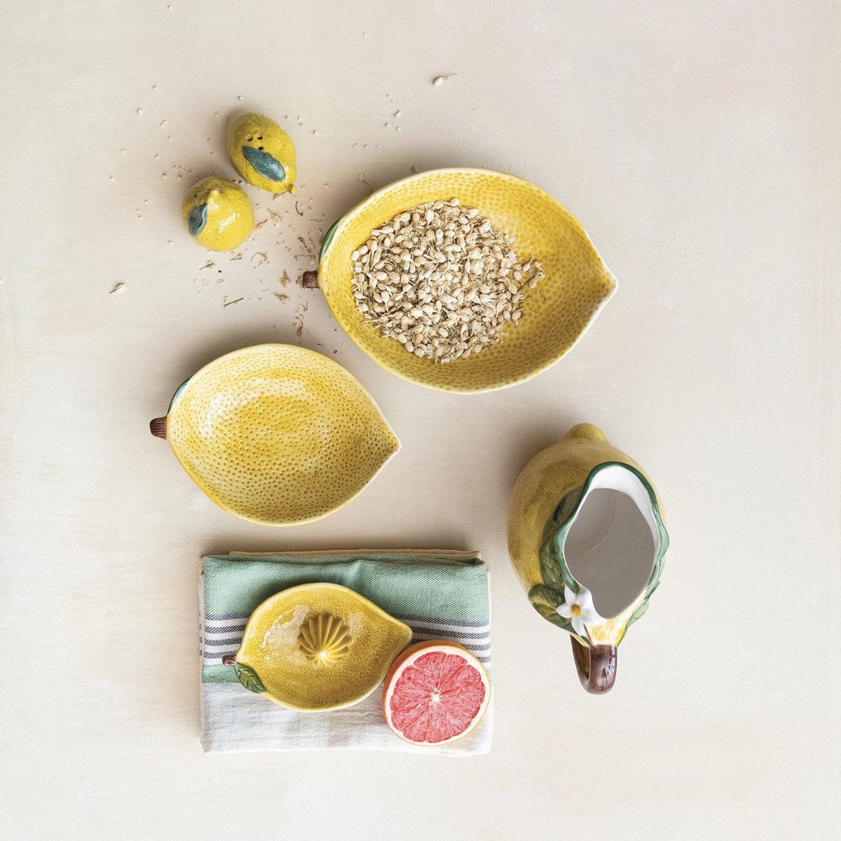 Stoneware lemon-shaped bowl in pale yellow with a textured rind pattern.