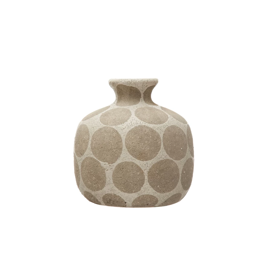 Terra-cotta ceramic vase featuring wax relief dot texture on a neutral silhouette.