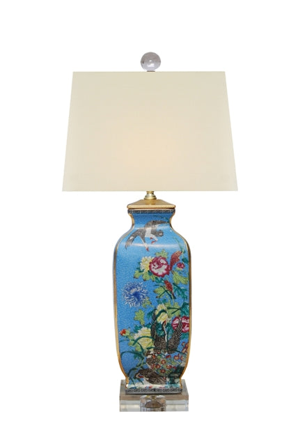 Porcelain square vase lamp with blue floral and bird motif, off-white shade, and acrylic base.