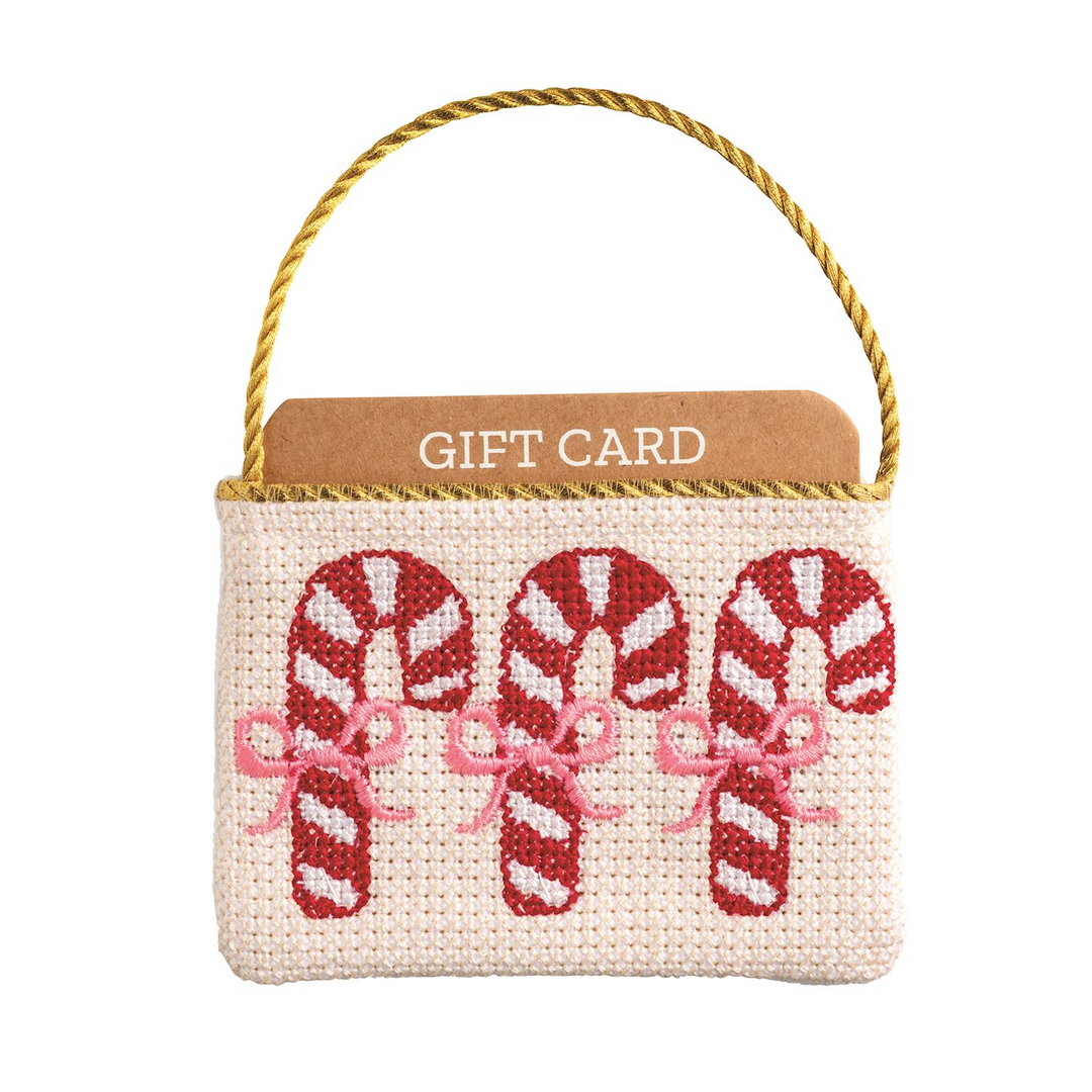 Needlepoint gift card pouch with three candy canes and a gold cord hanger.