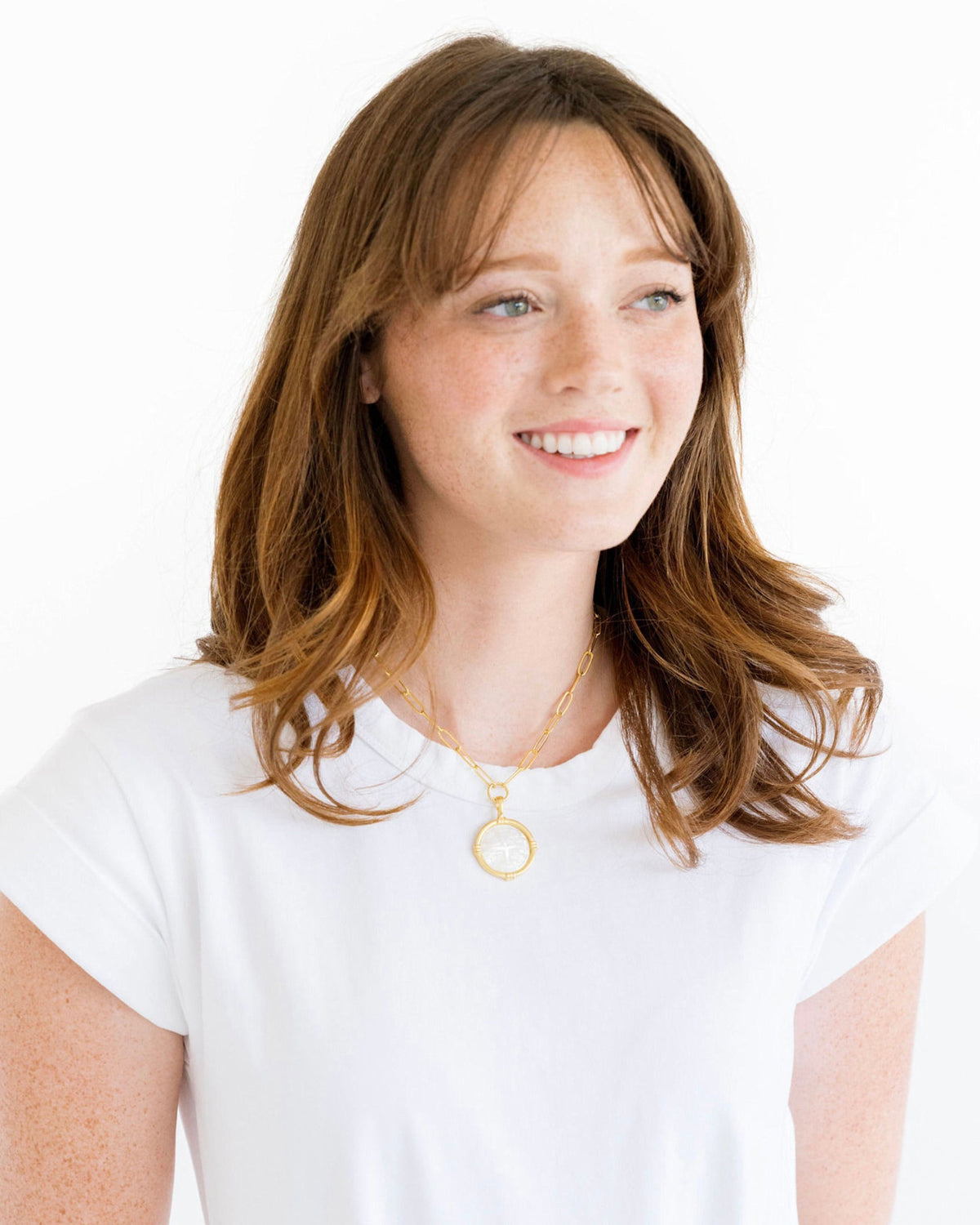Triple-plated gold necklace with a Mother of Pearl Jerusalem Cross pendant on an extender chain.