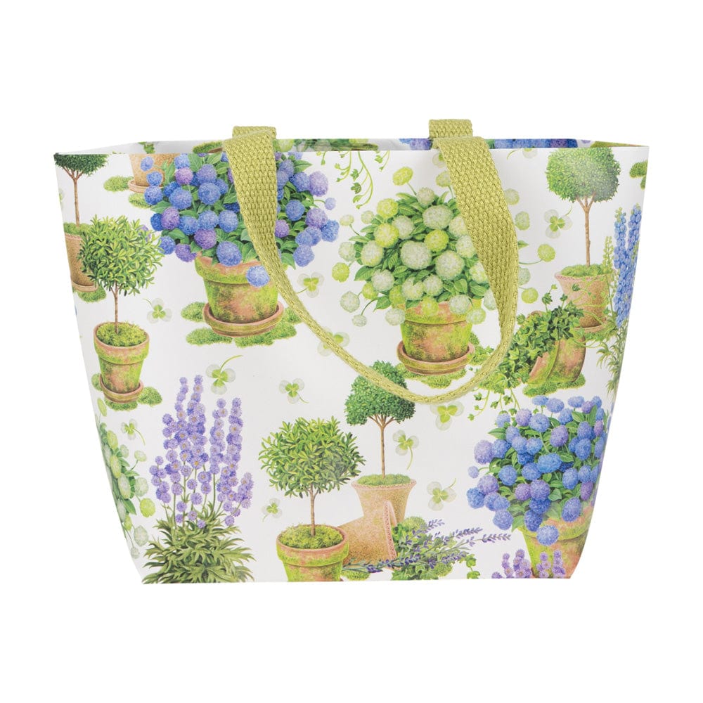 Small tote bag with a floral print of potted blue and white hydrangeas and green topiaries.