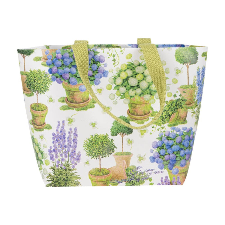 Small tote bag with a floral print of potted blue and white hydrangeas and green topiaries.