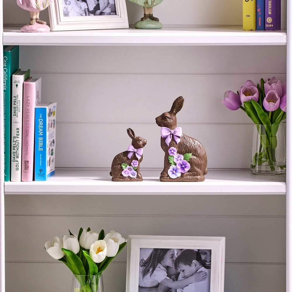 Resin chocolate bunny figurine with a pansy flower accent on its ear