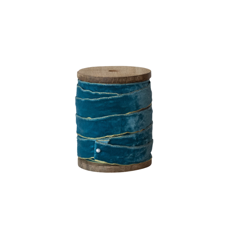 Teal velvet ribbon with metallic gold edges wound on a mango wood spool.