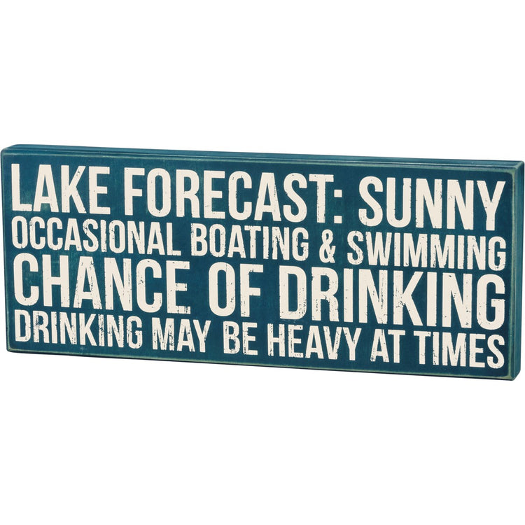 Blue wooden box sign with white text reading 'LAKE FORECAST: SUNNY OCCASIONAL BOATING & SWIMMING CHANCE OF DRINKING DRINKING MAY BE HEAVY AT TIMES'.