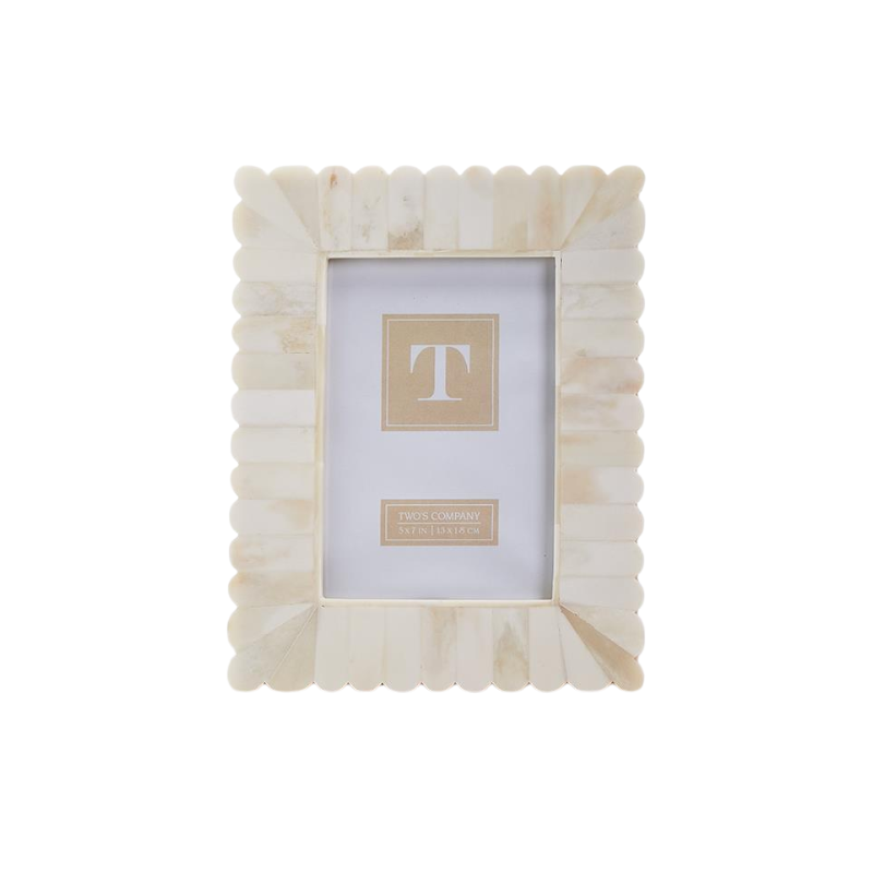 Scalloped bone photo frame with a cream and white marbled finish, standing vertically.
