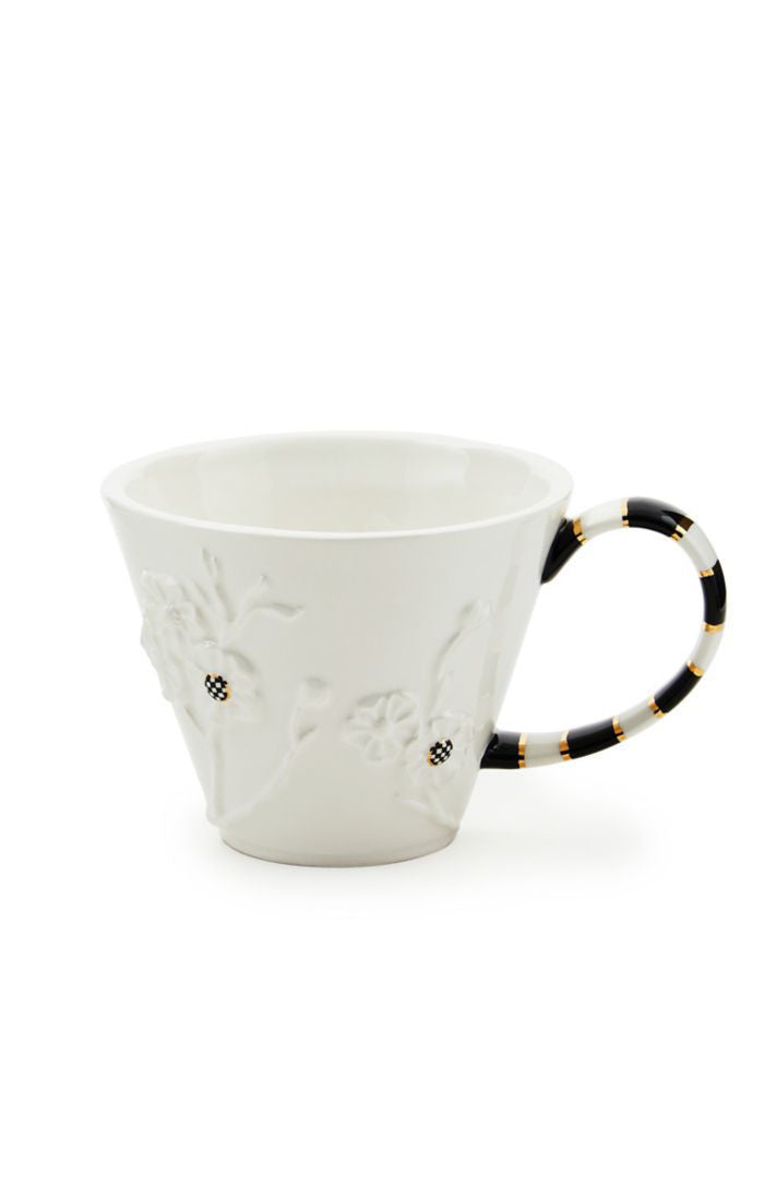 White Rabbit Ceramic Mug with embossed floral details and a black and white striped handle.