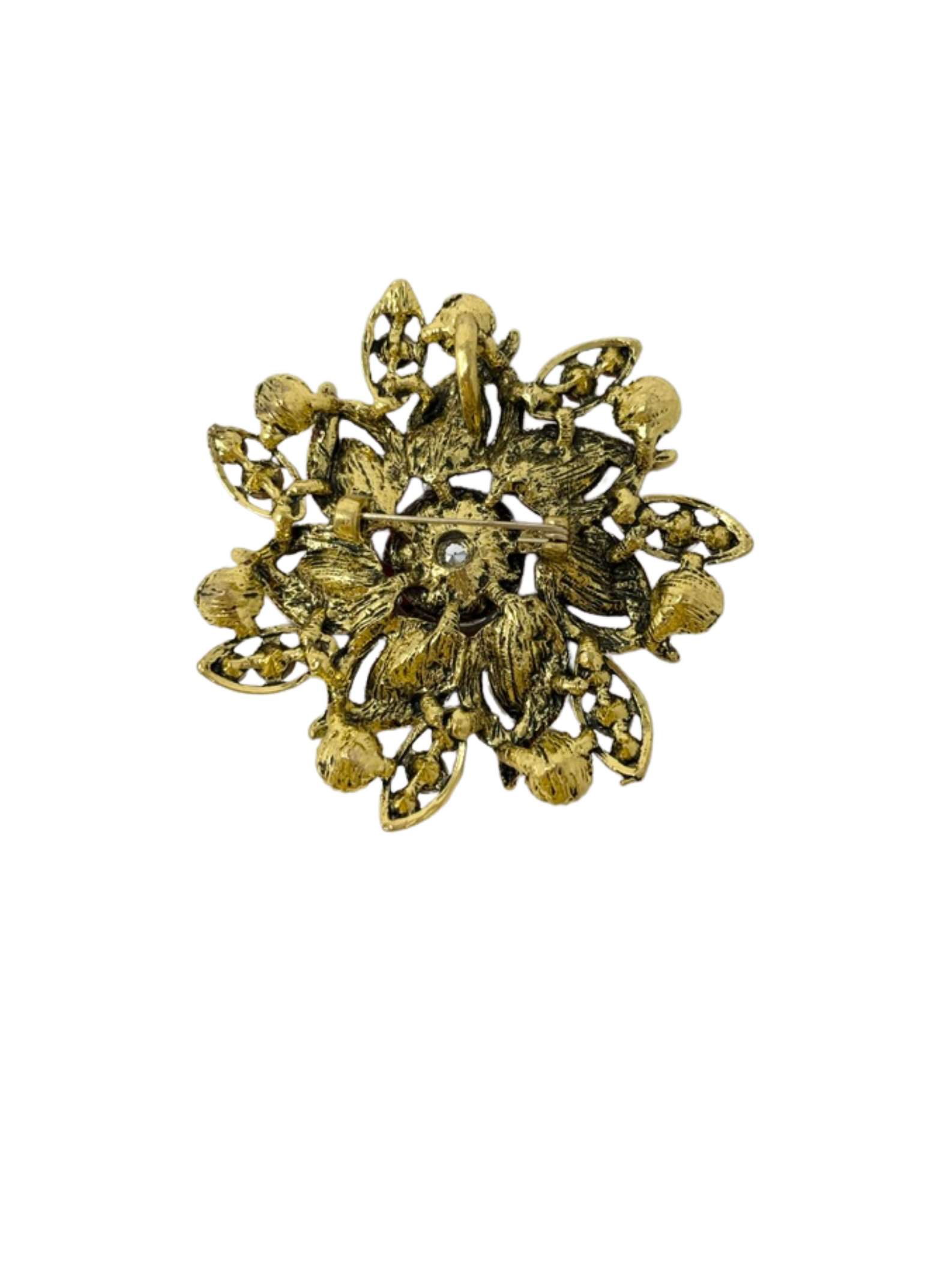 Back view of a gold-toned flower brooch with a pin fastener and textured metal finish.