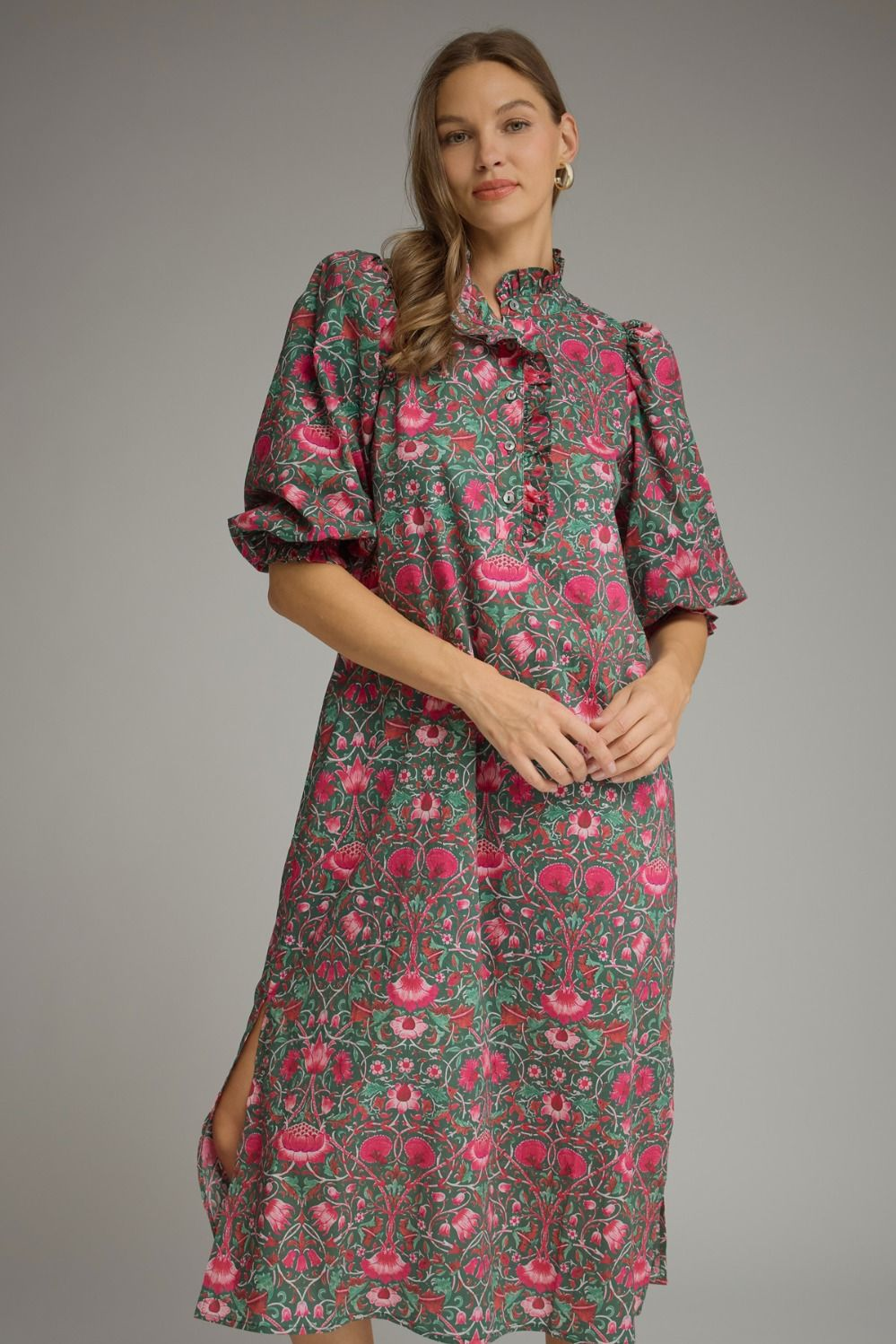 Aira midi dress with pink floral print on green, featuring short puff sleeves and a ruffled collar.