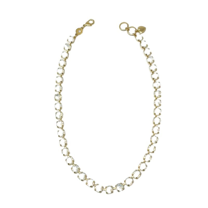 Gold-tone chain necklace featuring a series of clear, round bezel-set crystals.
