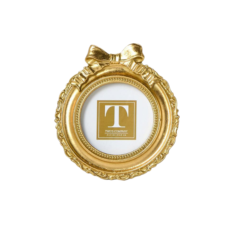 Round gold mini photo frame with an ornate border and a decorative bow on top.