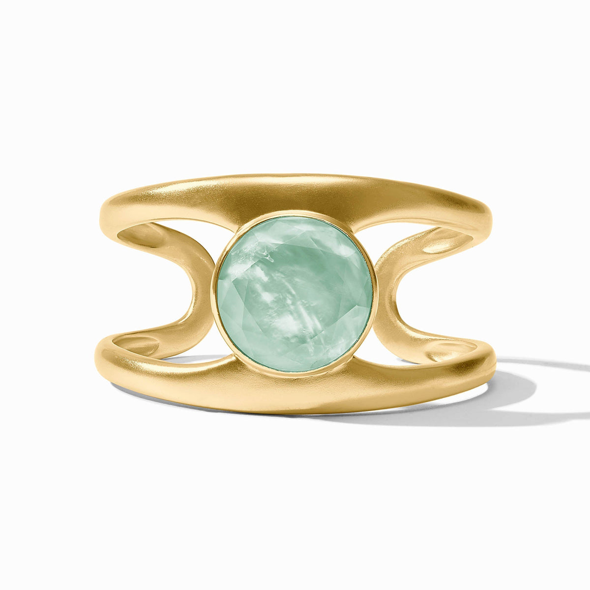 Laguna Stone Cuff featuring a round, faceted light green stone set in a wide gold-tone band.